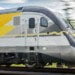 Miami, Florida - May 28, 2018: New and modern Brightline train on it’s way to Fort Lauderdale. This intercity train will connect from Miami to Orlando in 3 hours approximately.